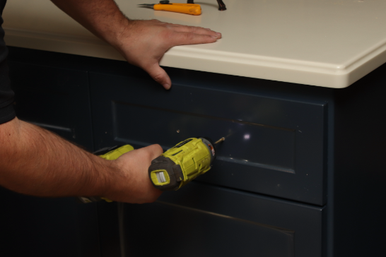 Securing the drawer front with hardware