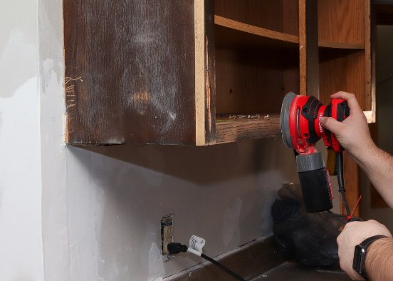 Sanding a cabinet frame