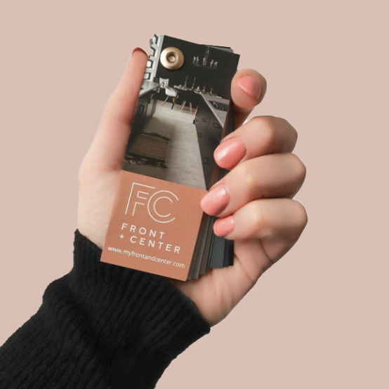 A hand holding a Front + Center color swatch fan