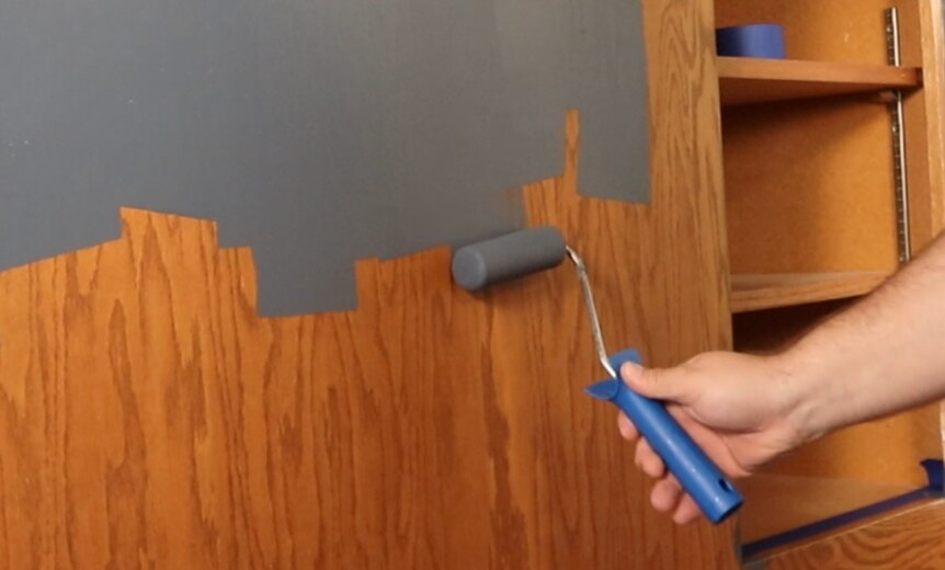 Painting a cabinet frame with a foam roller