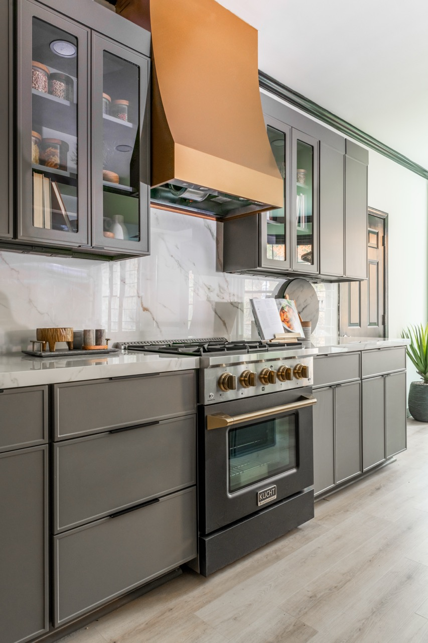 Gray Fineline cabinets beside a range