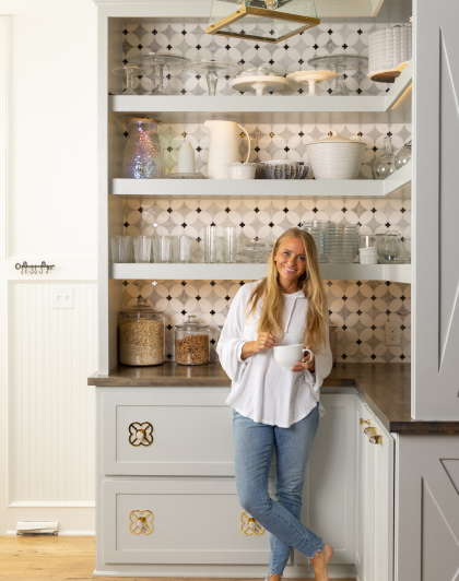 Tamara Day standing in a pantry with patterned tile