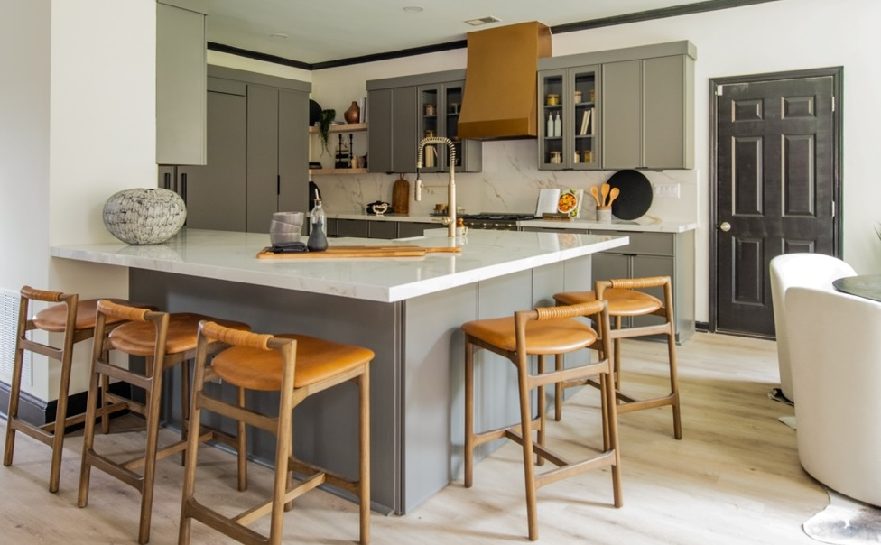 A refaced gray kitchen with an island and leather stools